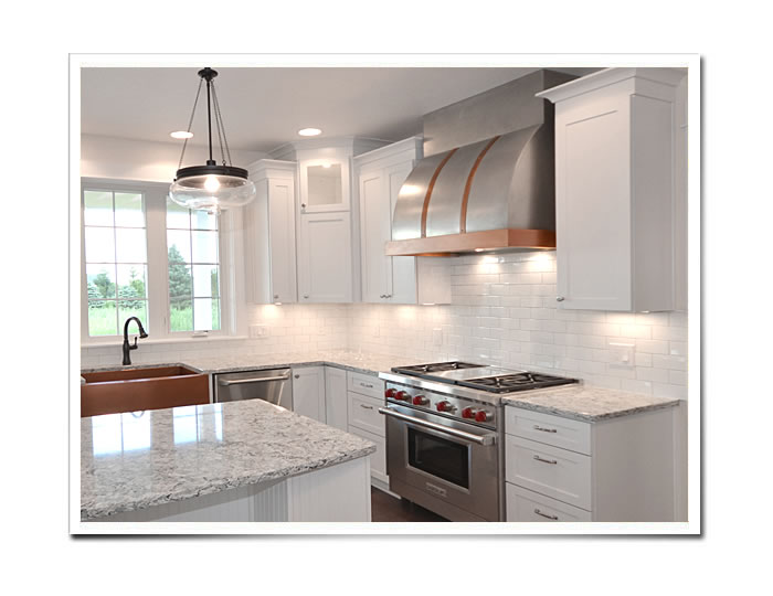 Barrel Range Hood in stainless steel and copper installed in a kitchen.