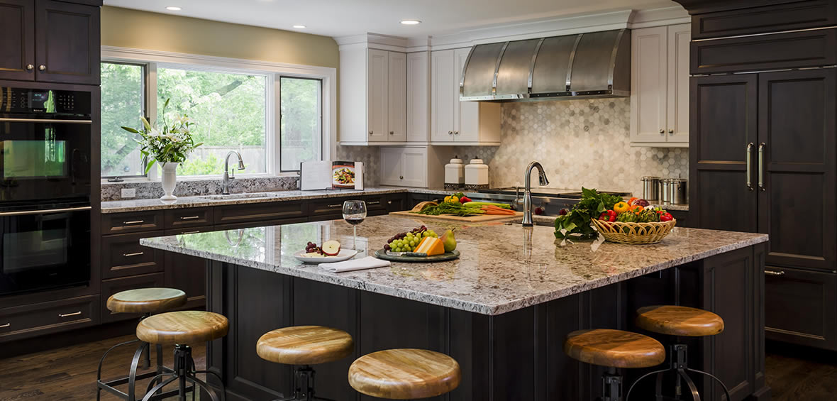 Custom stainless steel range hood with chrome strapping.