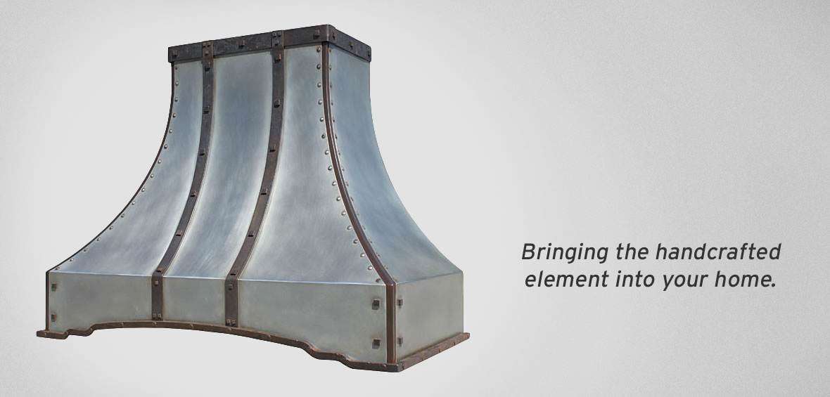 Photo of custom steel range hood with patina and forged strapping.