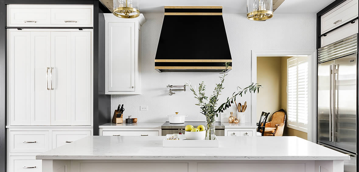 Photo of black powdercoated range hood with brass straps.