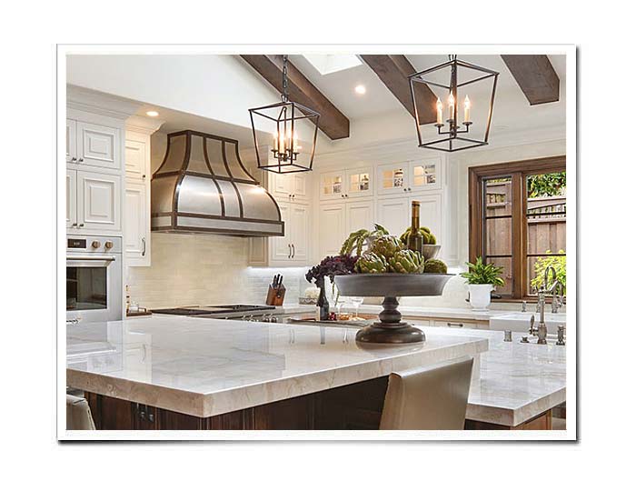 Stainless steel range hood with dark brown brass straps